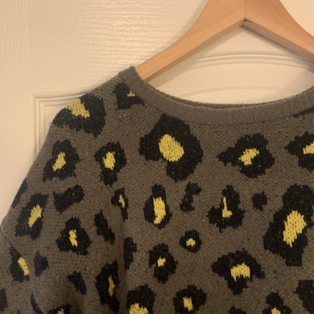 Large printed sweater. Fits like a medium, slightly cropped.